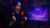 Excited gamer sees Dota 2 The International logo on screen. Background signs hint at 50M prizepool and Collectors Cache for TI14 Battle Pass.